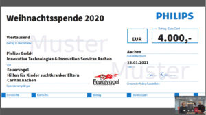Eine Spendenbescheinigung von Philips über 4.000 Euro an Caritas Aachen und Feuervogel, datiert auf den 25.01.2021, mit Spendenangaben und zwei Personen, die während eines Videoanrufs in der rechten unteren Ecke zu sehen sind.
